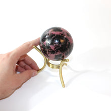 Load image into Gallery viewer, Rhodonite polished crystal sphere with stand | ASH&amp;STONE Crystals Shop Auckland NZ
