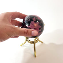 Load and play video in Gallery viewer, Rhodonite polished crystal sphere with stand | ASH&amp;STONE Crystals Shop Auckland NZ
