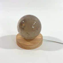 Load and play video in Gallery viewer, Smoky quartz crystal sphere on LED lamp base | ASH&amp;STONE Crystals Shop Auckland NZ
