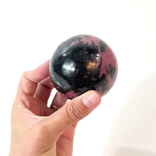 Load and play video in Gallery viewer, Rhodonite polished crystal sphere | ASH&amp;STONE Crystals Shop Auckland NZ
