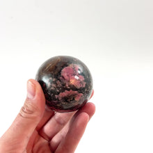 Load and play video in Gallery viewer, Rhodonite polished crystal sphere | ASH&amp;STONE Crystals Shop Auckland NZ
