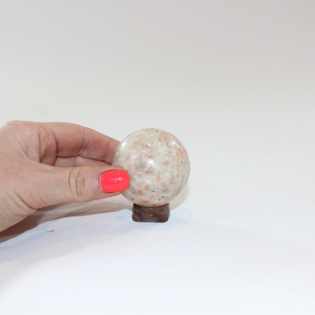 Sunstone Polished Crystal Sphere on a Small Quartz Crystal Stand. Free express shipping. Shop online from ASH&STONE crystal shop Auckland NZ. AfterPay available.