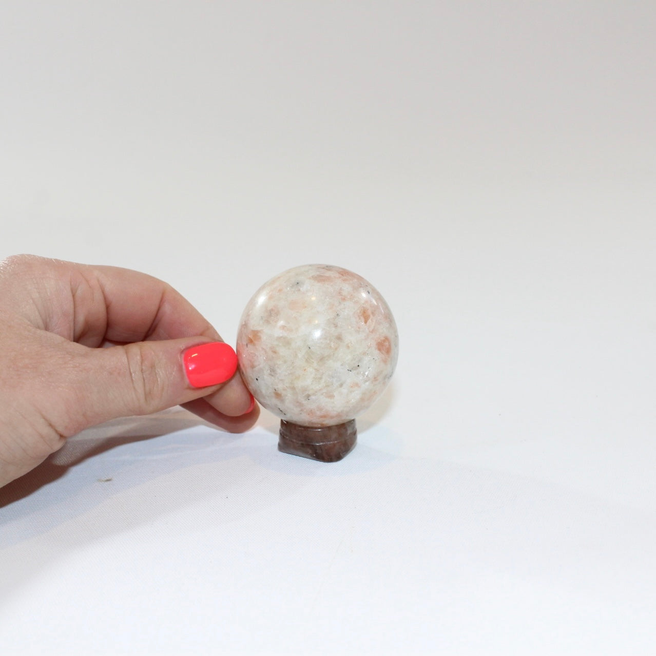 Sunstone Polished Crystal Sphere on a Small Quartz Crystal Stand. Free express shipping. Shop online from ASH&STONE crystal shop Auckland NZ. AfterPay available.