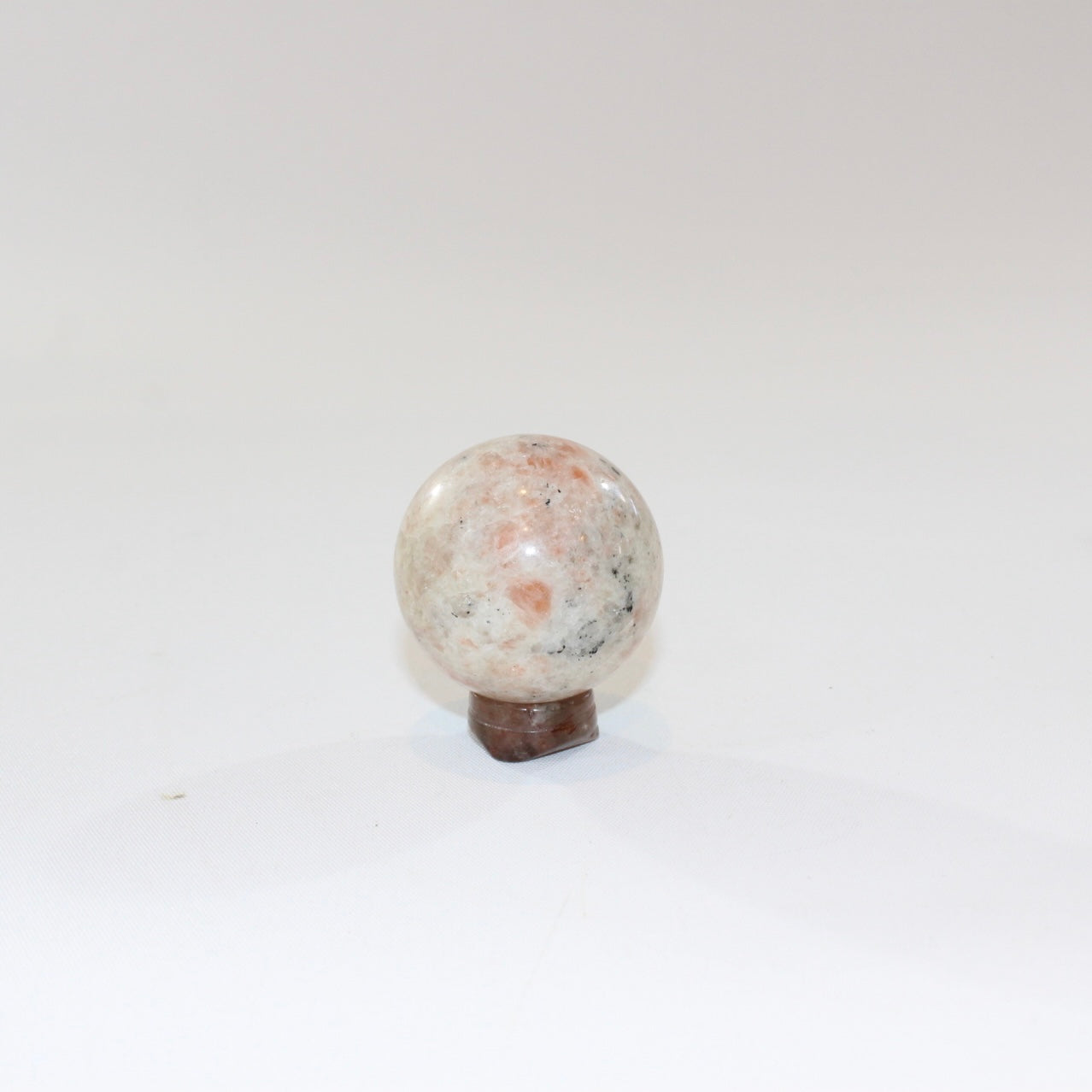 Sunstone Polished Crystal Sphere on a Small Quartz Crystal Stand. Free express shipping. Shop online from ASH&STONE crystal shop Auckland NZ. AfterPay available.