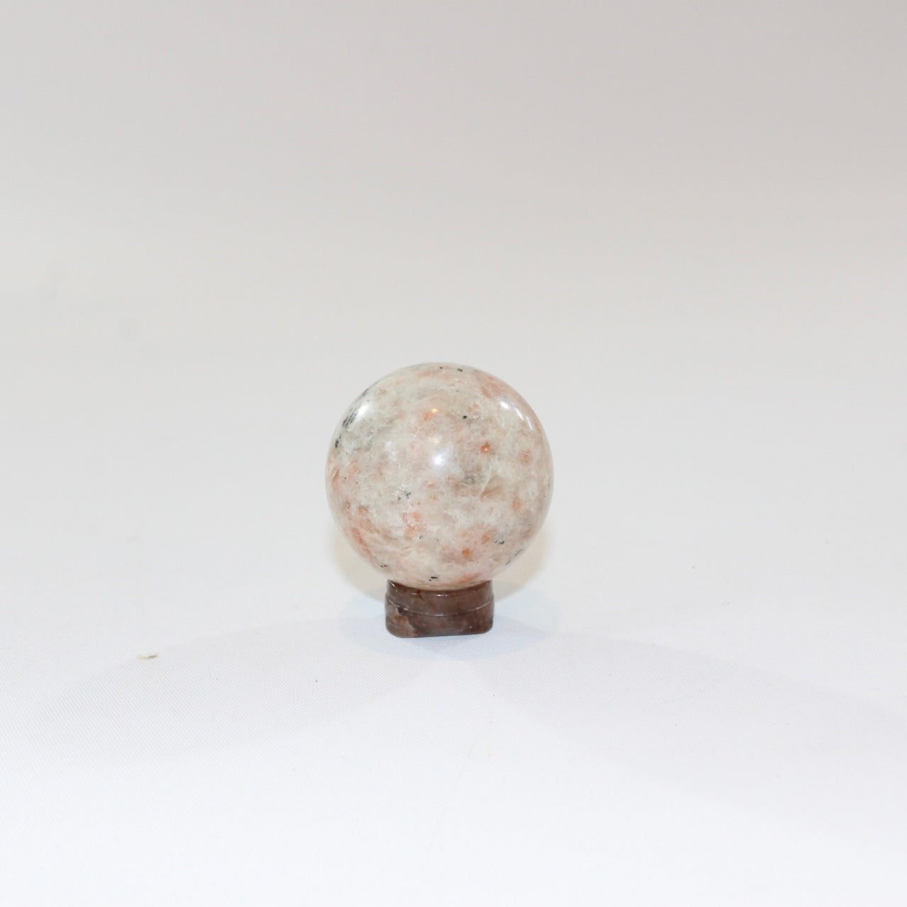 Sunstone Polished Crystal Sphere on a Small Quartz Crystal Stand. Free express shipping. Shop online from ASH&STONE crystal shop Auckland NZ. AfterPay available.