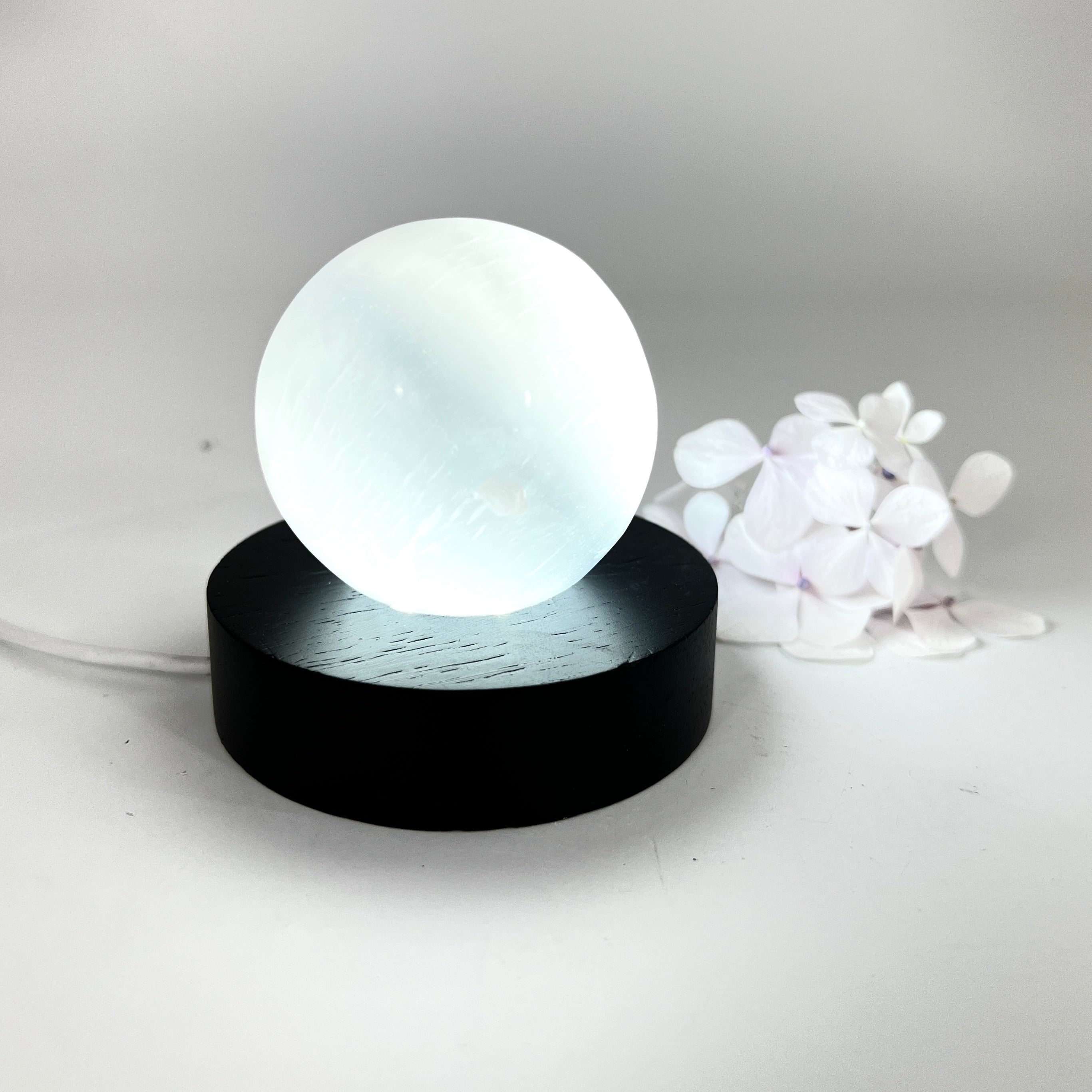 Crystals NZ: Selenite crystal sphere lamp on black LED wooden base