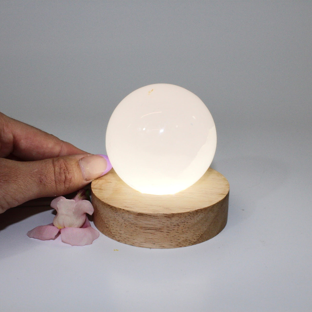 Crystal Lamps NZ: Pink mangano calcite crystal lamp on LED wooden base
