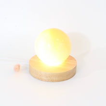 Load image into Gallery viewer, Orange selenite crystal sphere lamp on LED wooden base | ASH&amp;STONE Crystals Shop Auckland NZ
