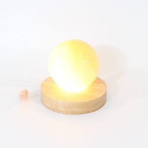 Orange selenite crystal sphere lamp on LED wooden base | ASH&STONE Crystals Shop Auckland NZ