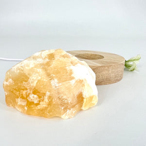 Crystal Lamps NZ: Orange calcite crystal lamp with LED wooden base