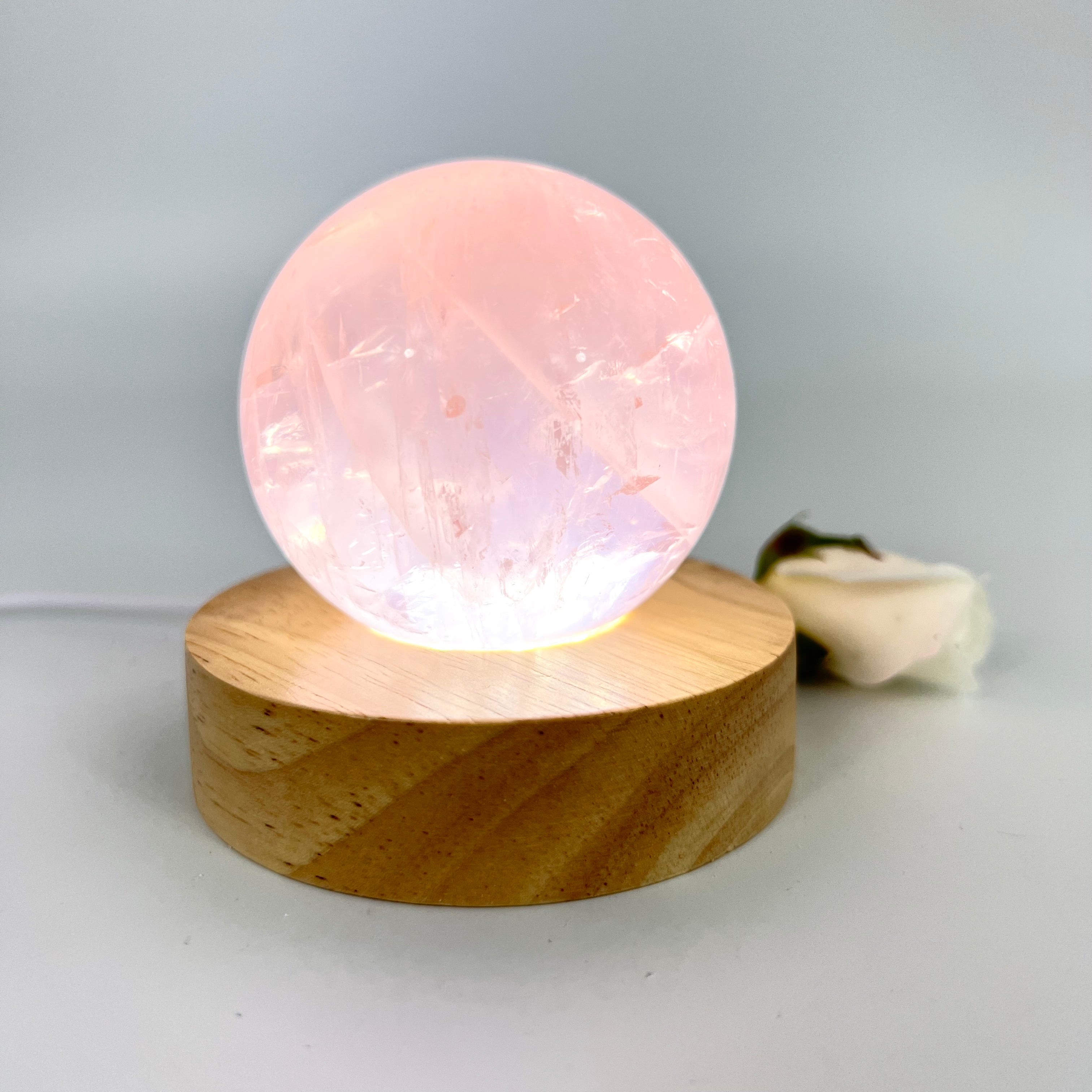 Crystal Lamps NZ: Rose quartz crystal sphere lamp on LED wooden base