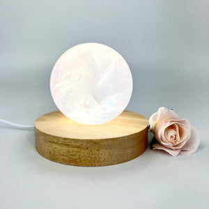 Crystal Lamps NZ: Rose quartz crystal sphere lamp on LED wooden base