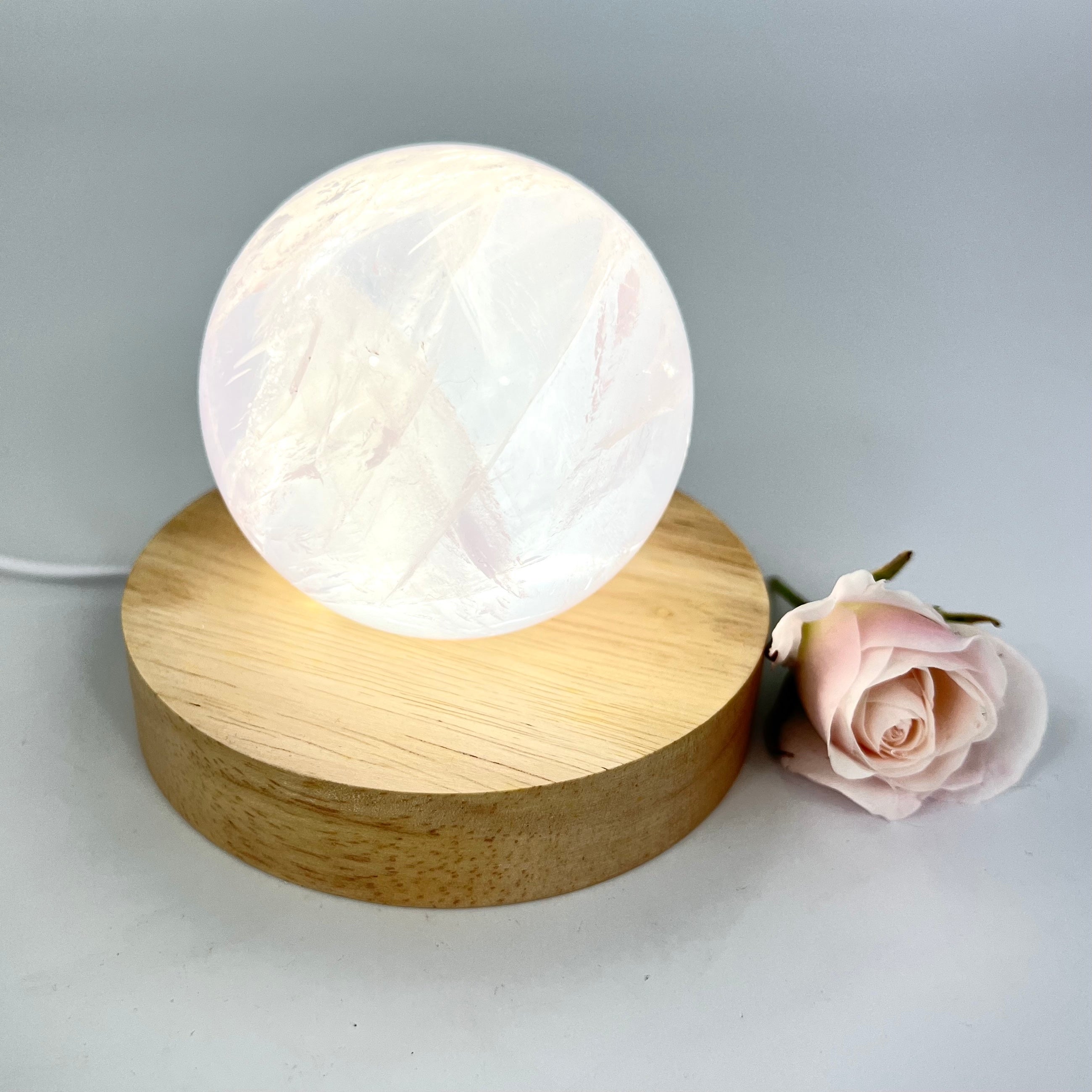 Crystal Lamps NZ: Rose quartz crystal sphere lamp on LED wooden base