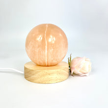 Load image into Gallery viewer, Crystal Lamps NZ: Orange selenite crystal sphere lamp on LED wooden base
