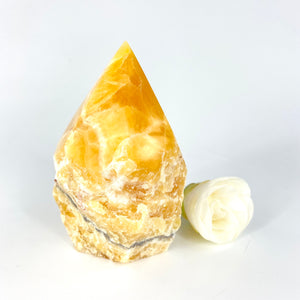 Crystals NZ: Orange calcite crystal polished point