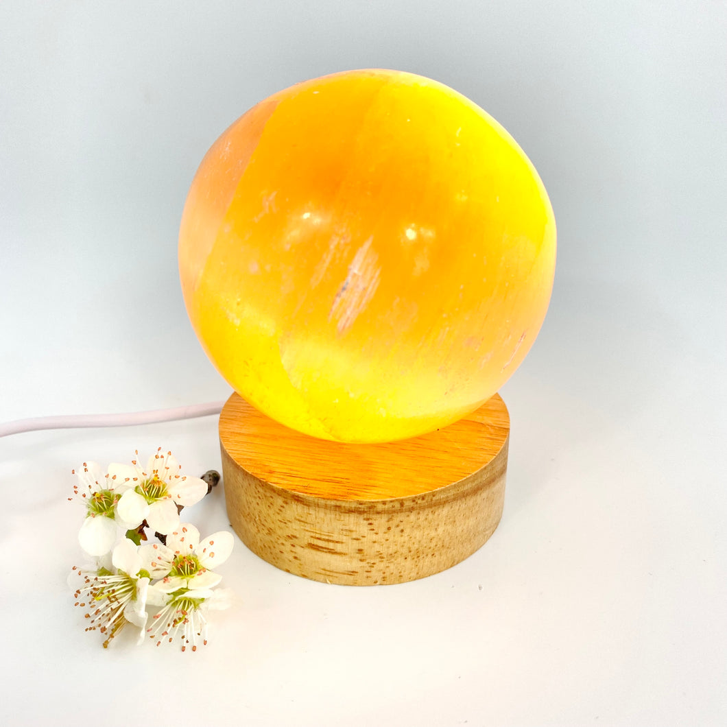 Crystals NZ: Orange selenite crystal sphere on LED lamp base