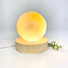 Load image into Gallery viewer, Crystals NZ: Orange selenite crystal sphere lamp on LED wooden base
