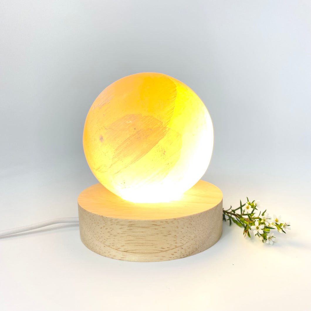 Crystals NZ: Orange selenite crystal sphere lamp on LED wooden base